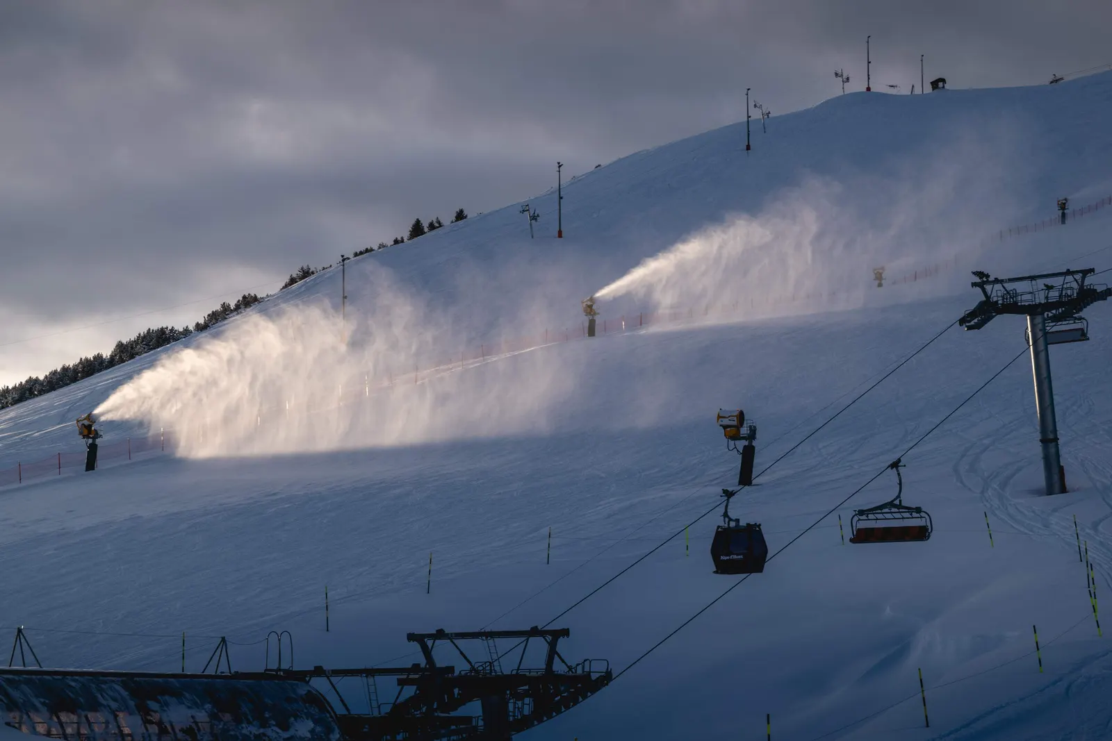 Snowmaking guns blowing on mountain