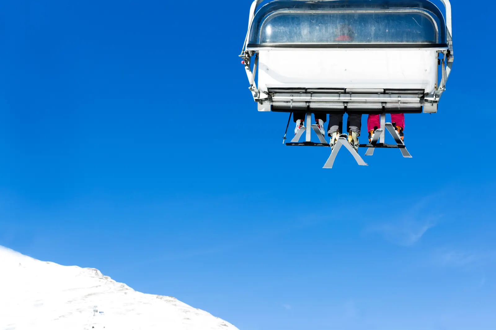 Skiers sitting in chair lift